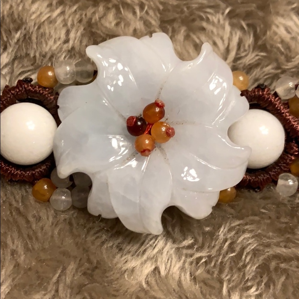 Brown braided bracelet with jade flower